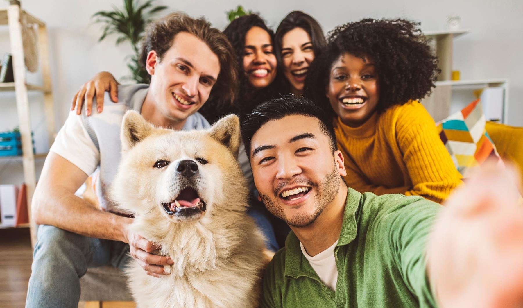 a group of people posing for a photo with a dog